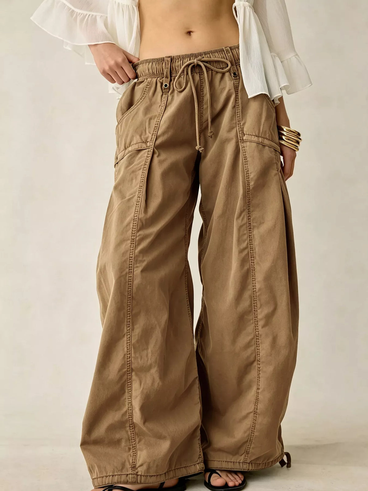 High-waisted cargo wide-leg pants in tan with drawstring waist and side cargo pockets