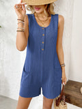 Royal blue sleeveless romper with round neck, button placket, and side pockets