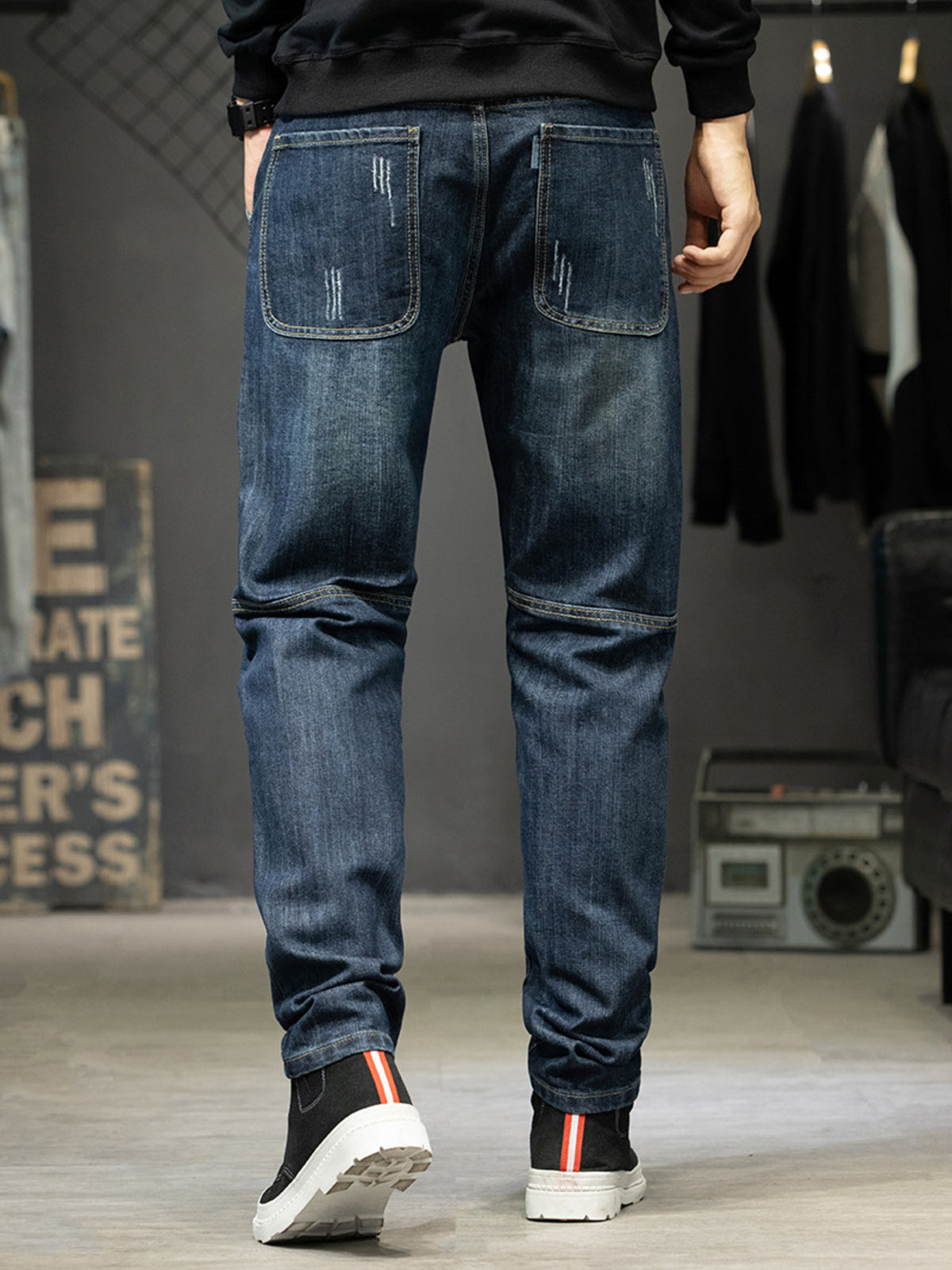 Men's slim-fit distressed stretch cotton jeans, dark blue, back with fading and stitching