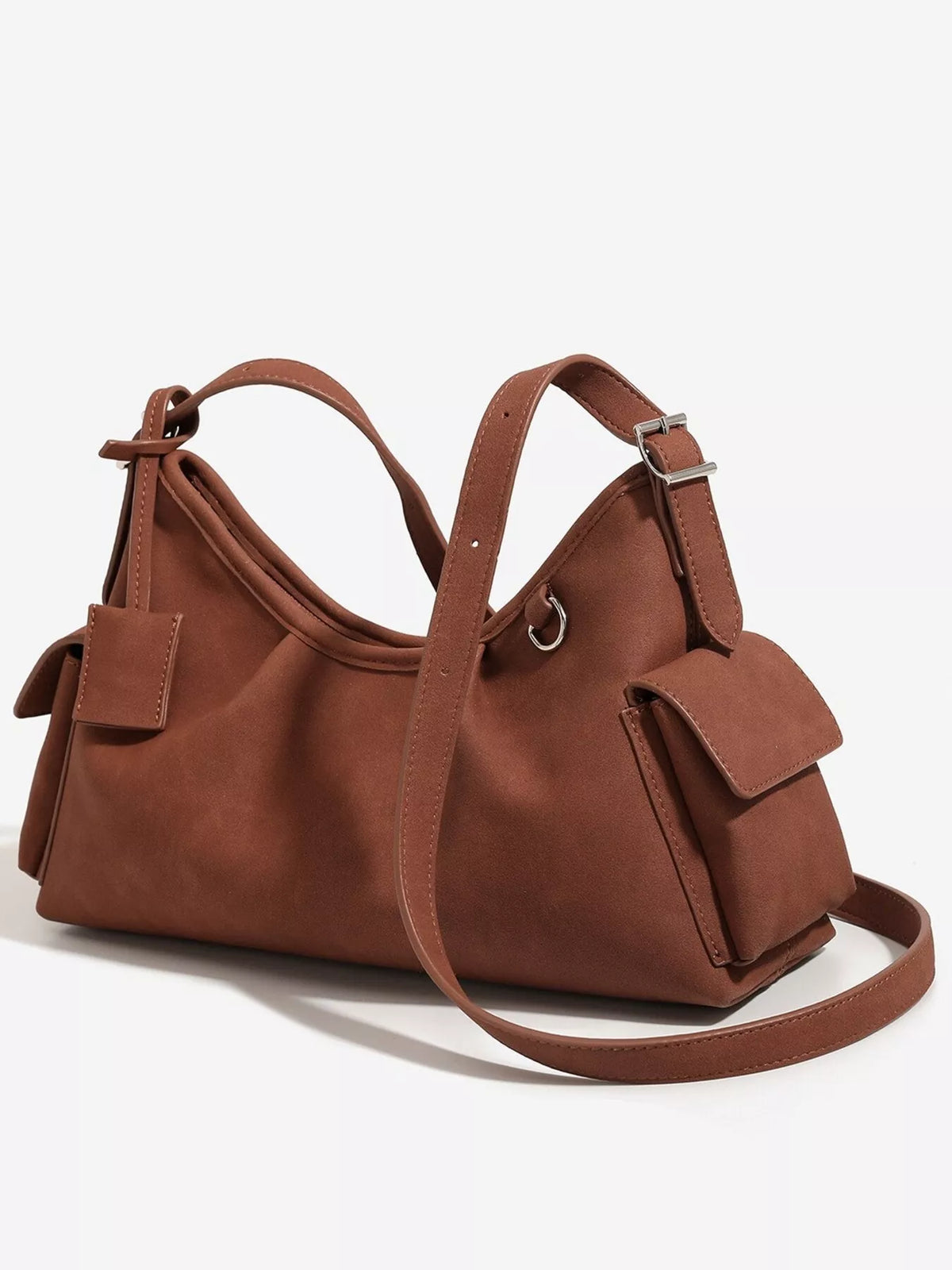 Brown suede shoulder bag with wide strap, ruched top, and two front buckle tabs