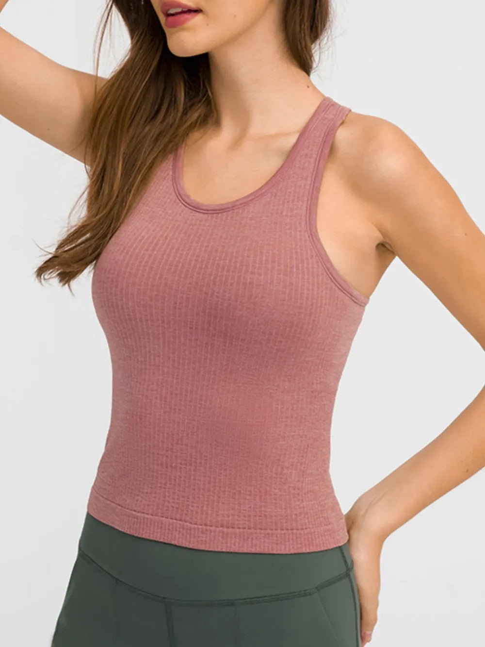 Dusty pink active tank top with round neck and racerback straps for workouts.