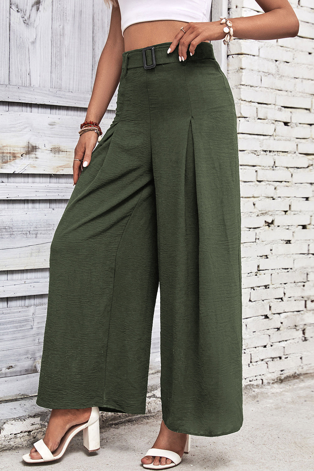 High-waisted wide-leg pants in deep green with front pleat and wide-leg silhouette.