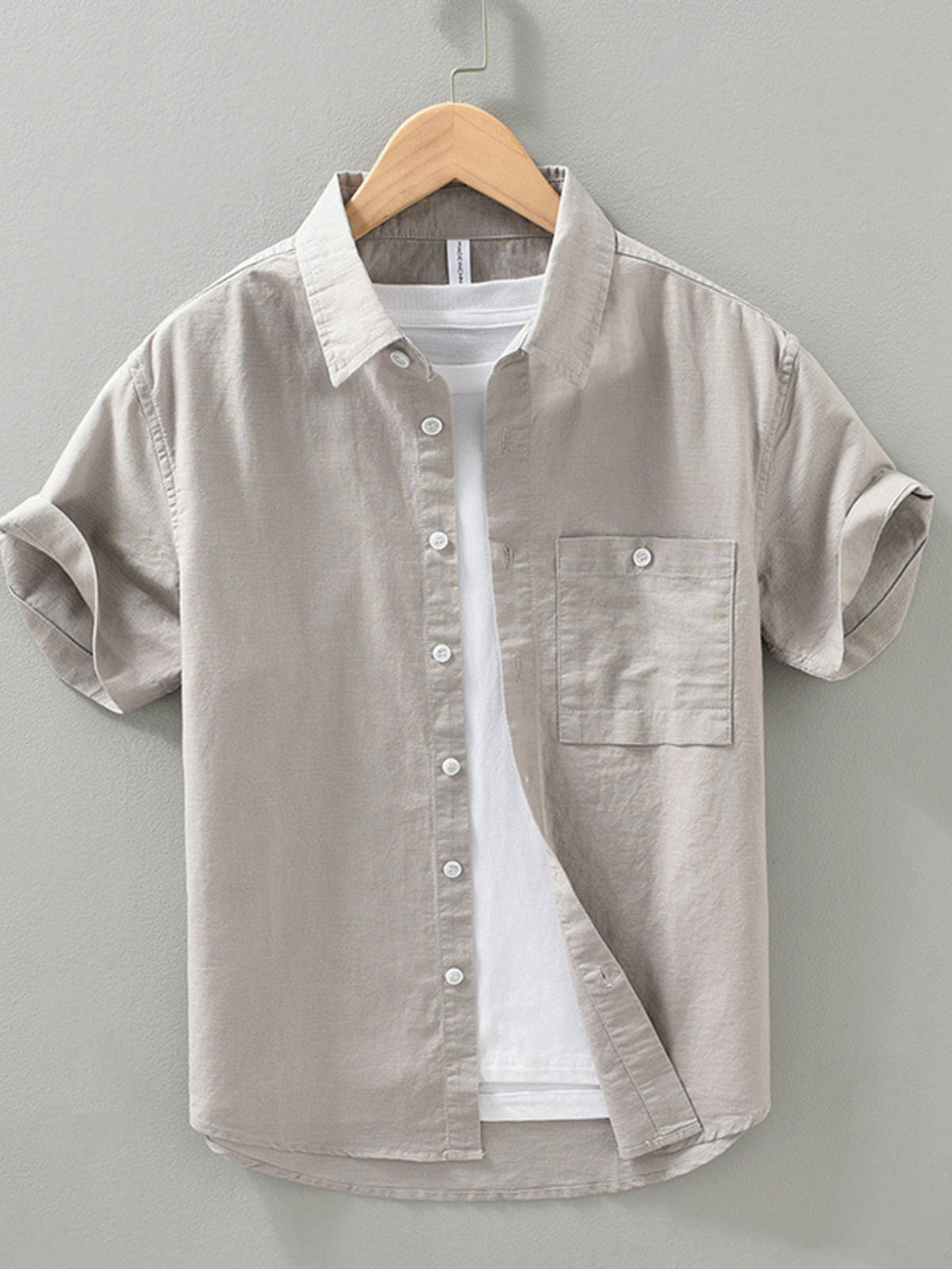 Light gray men’s short-sleeve button shirt with front buttons and chest pocket