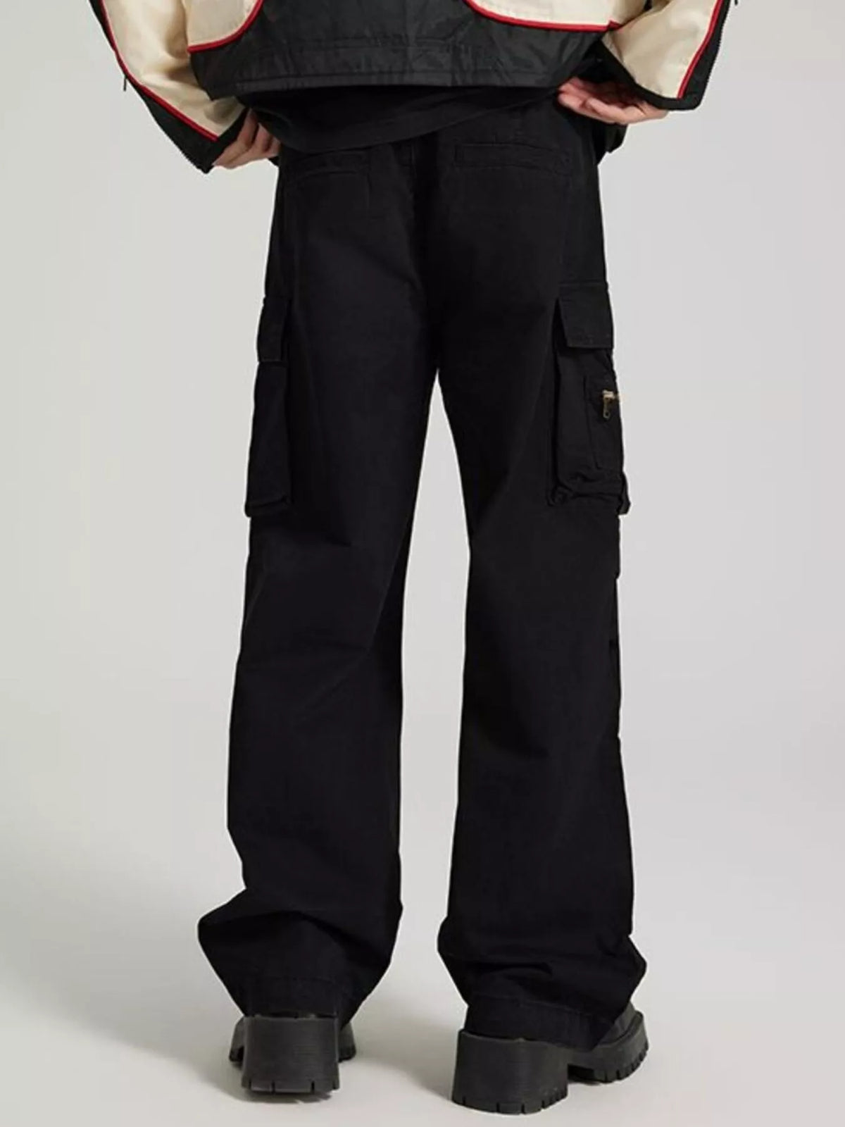 Black cargo jeans with front cargo pockets and metal zipper detail on right leg.