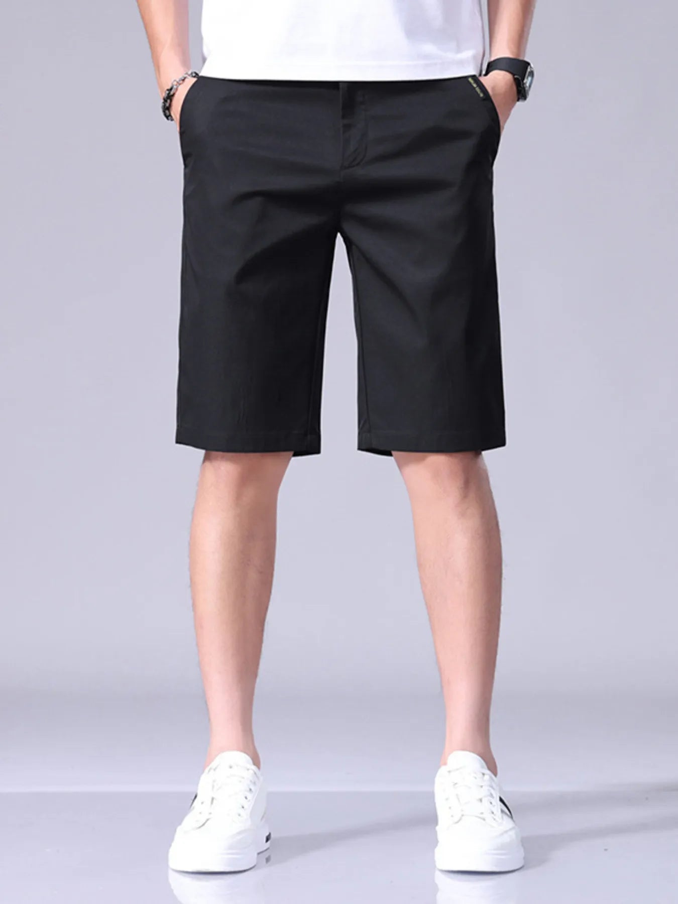 Black men's casual shorts with pockets and belt loops, knee-length style