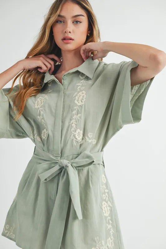 Dusty sage collared romper with embroidered front, button placket, and waist tie