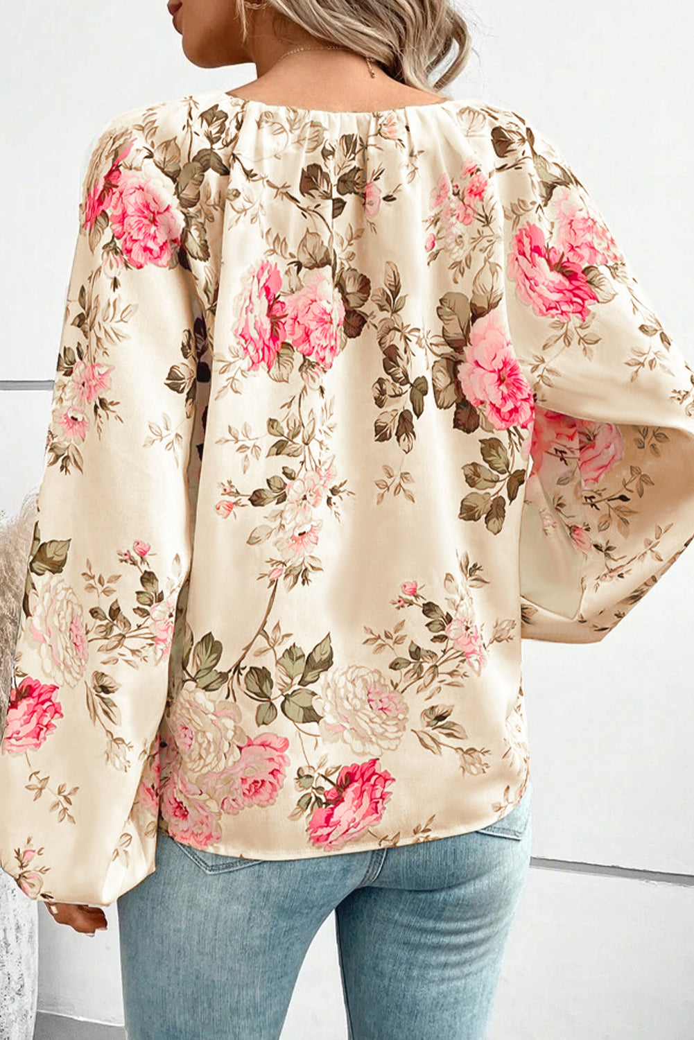 Beige floral blouse back view with long balloon sleeves