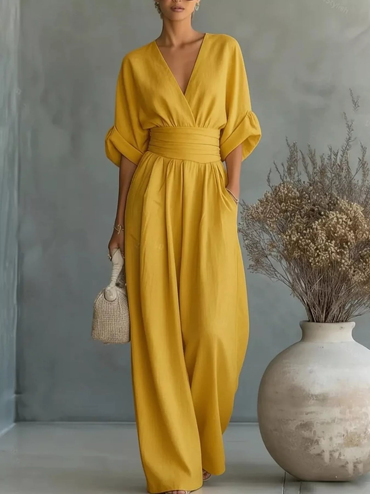 Yellow wide-leg jumpsuit with V-neck, half sleeves, and gathered waist