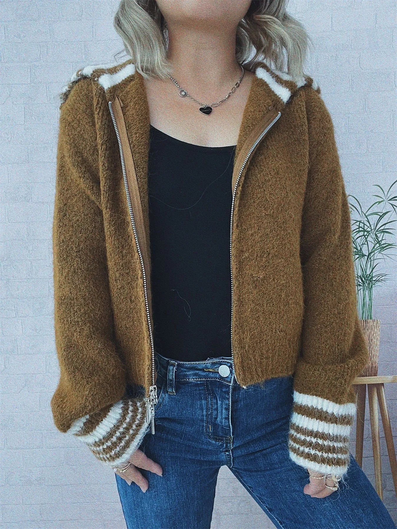 Brown zip-up cardigan with striped collar trim and ribbed cuffs, open front