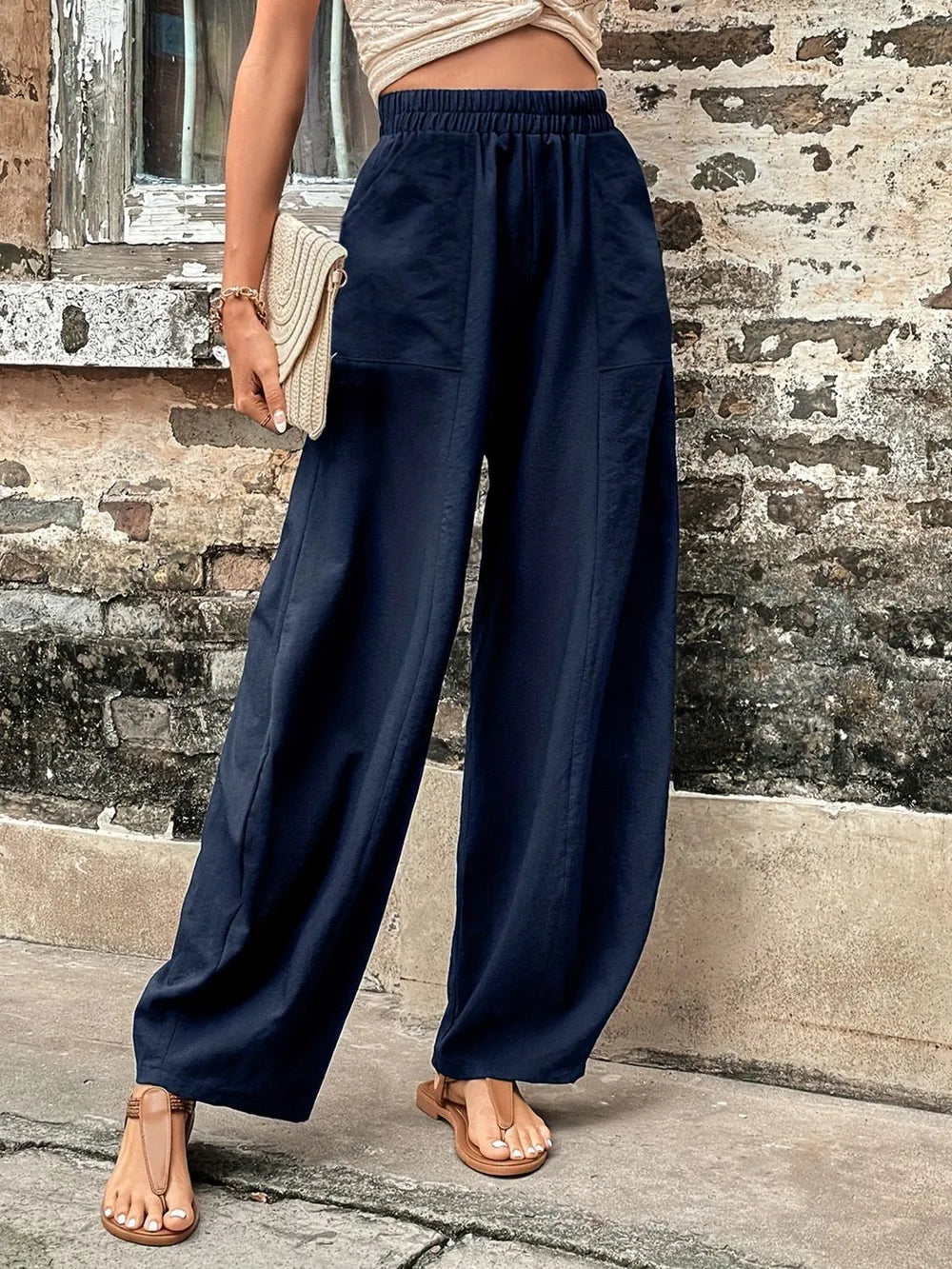 Dark blue elastic-waist pants with side pockets, loose wide-leg silhouette