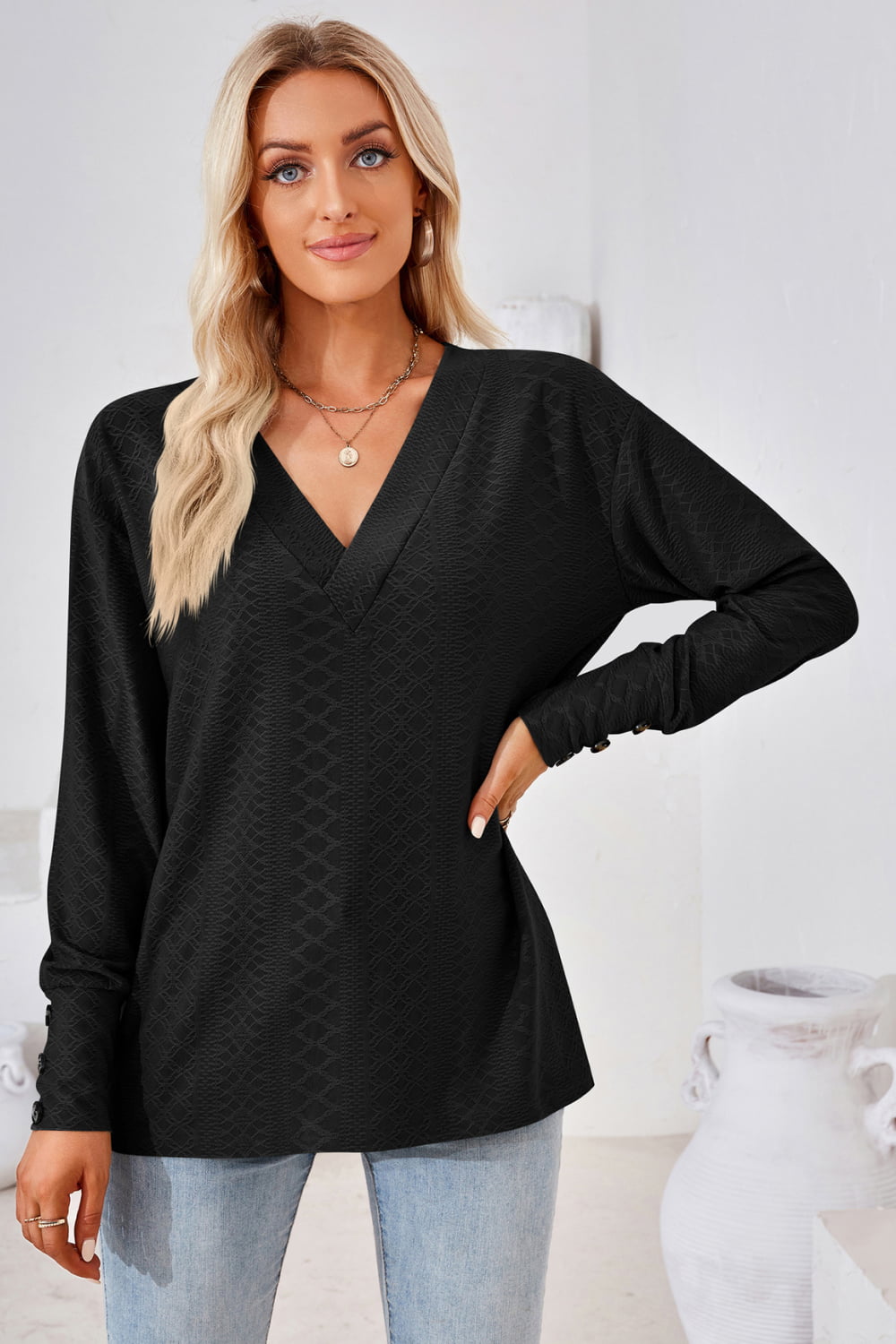 Black V-neck long-sleeve blouse with textured diamond pattern and long sleeves