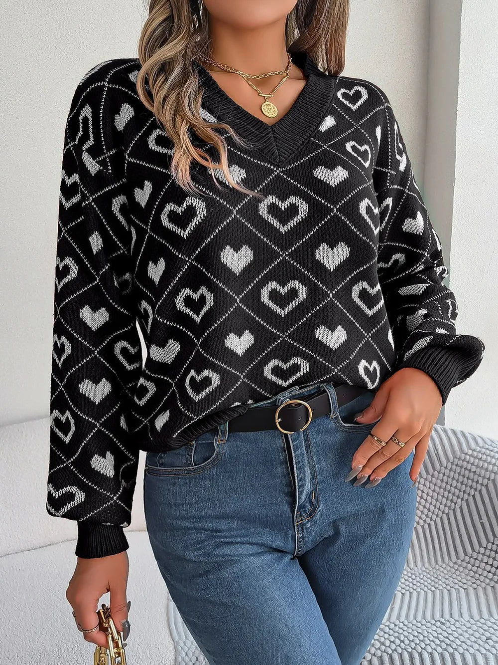 Black heart-pattern V-neck knit sweater with long sleeves and ribbed hem