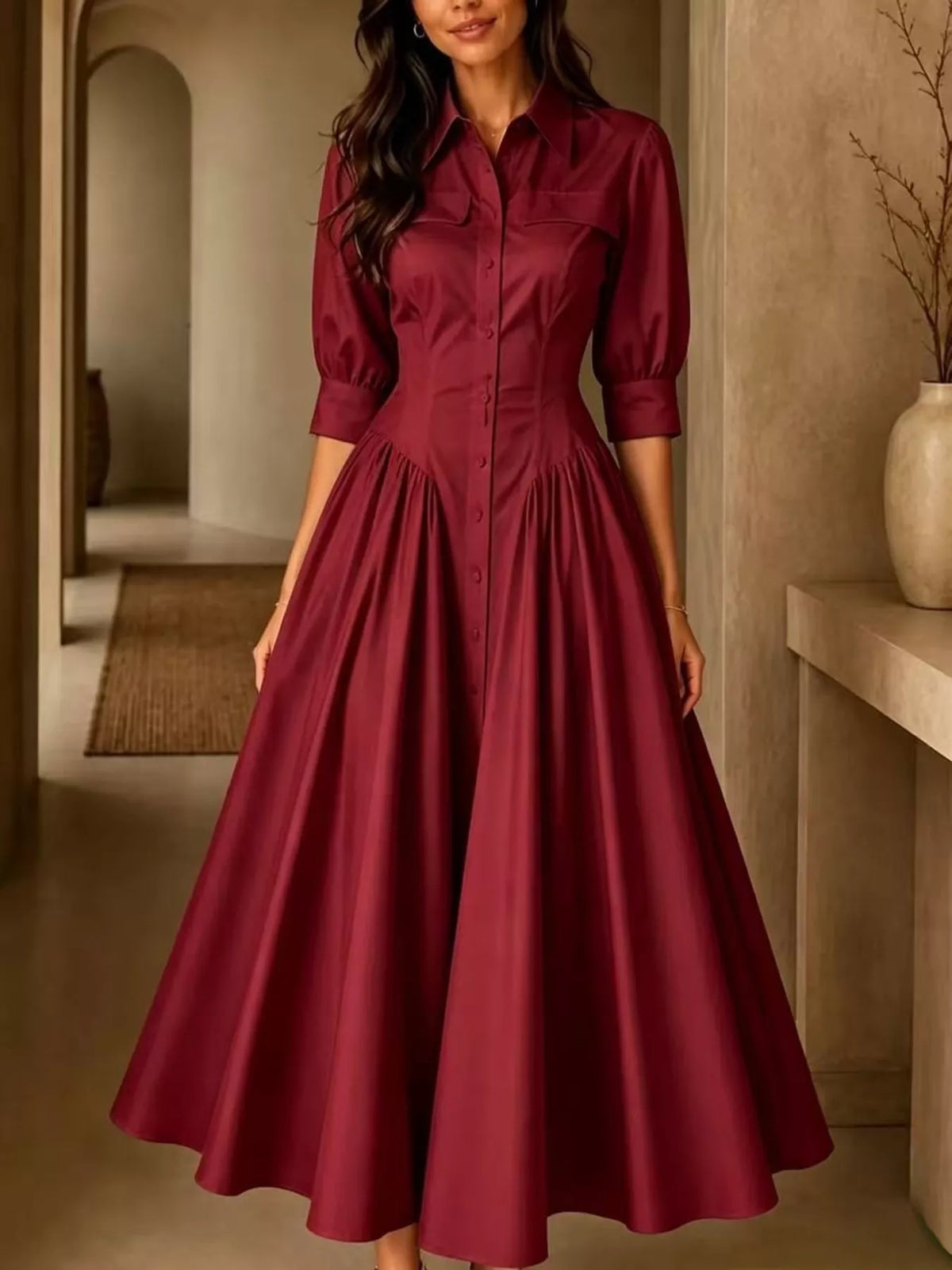 Burgundy button-down shirt dress with cinched waist, 3/4 puff sleeves, and pleated skirt.