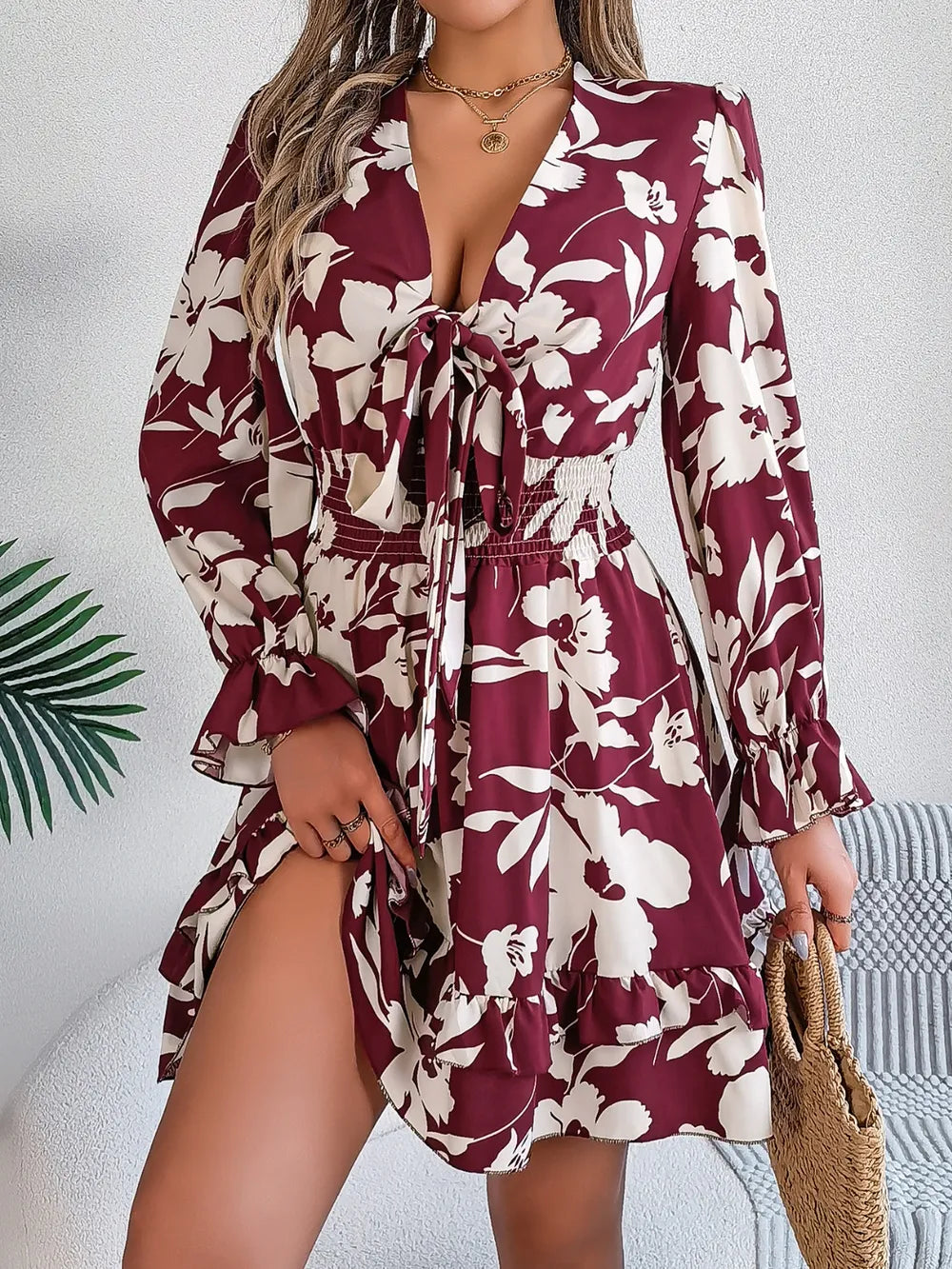 Burgundy floral long-sleeve dress with tied V-neck and tiered ruffled skirt