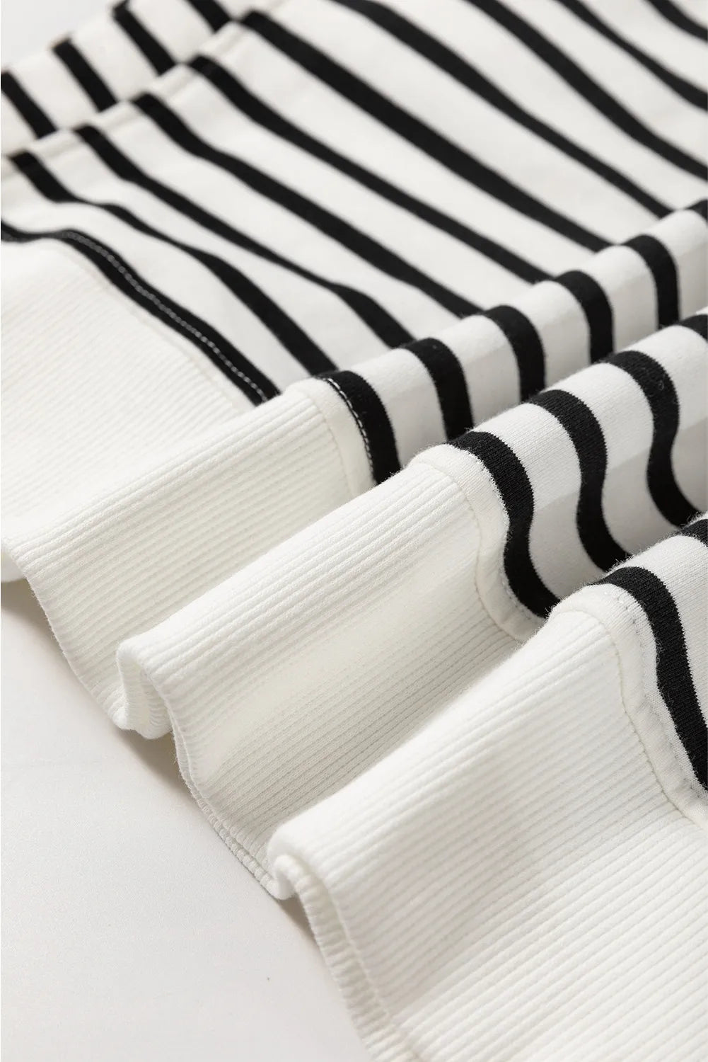 Black-and-cream striped long-sleeve sweatshirt cuff and hem with ribbed texture