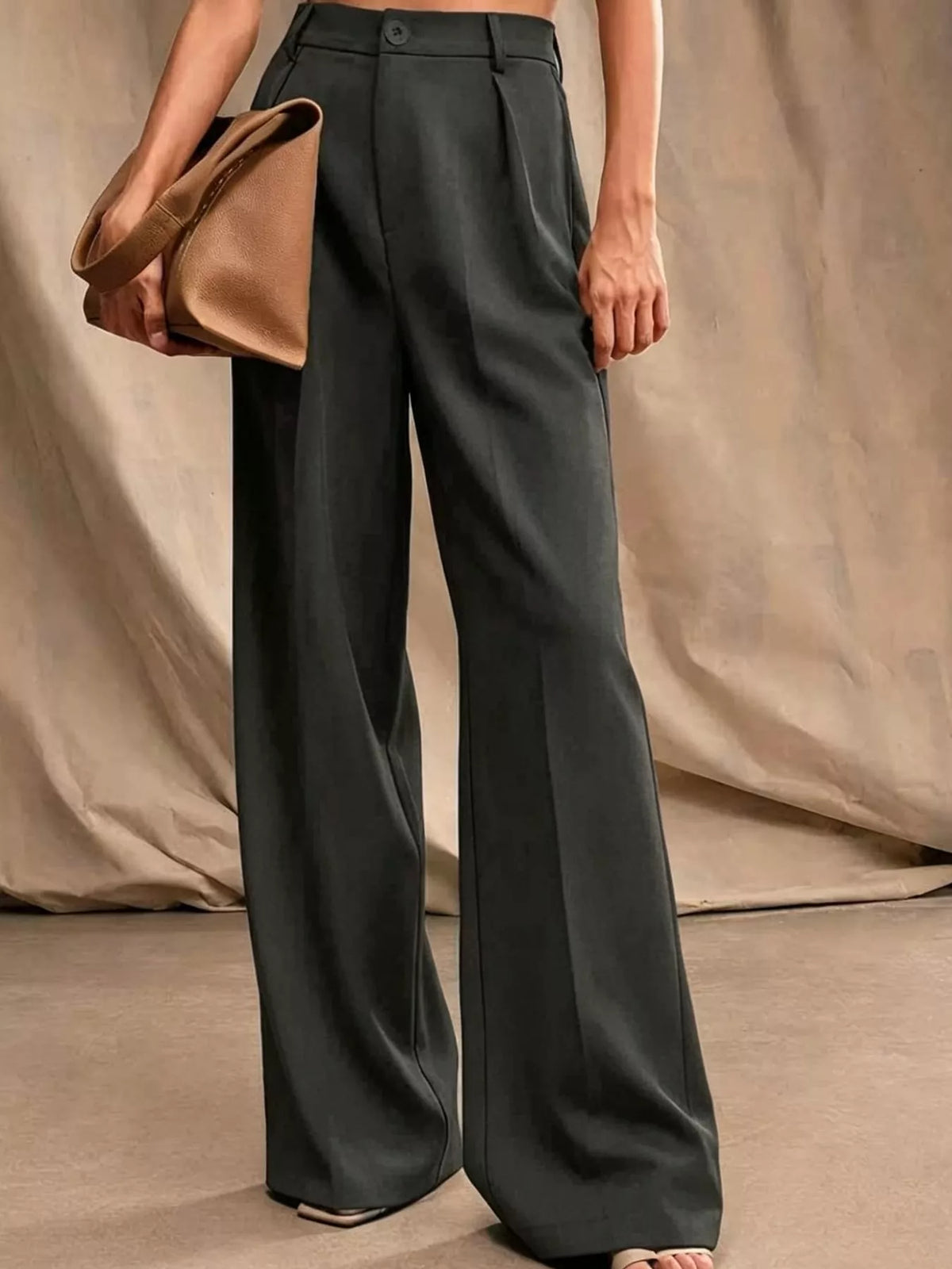 Black high-waisted pleated wide-leg pants with button front and relaxed straight legs