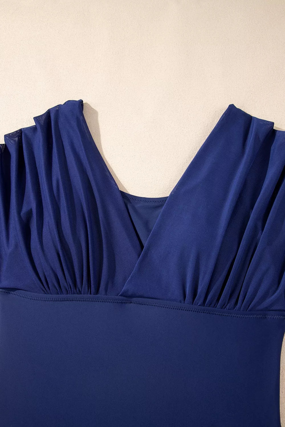 Navy V-neck swimsuit bodice with ruched, draped fabric and gathered shoulders