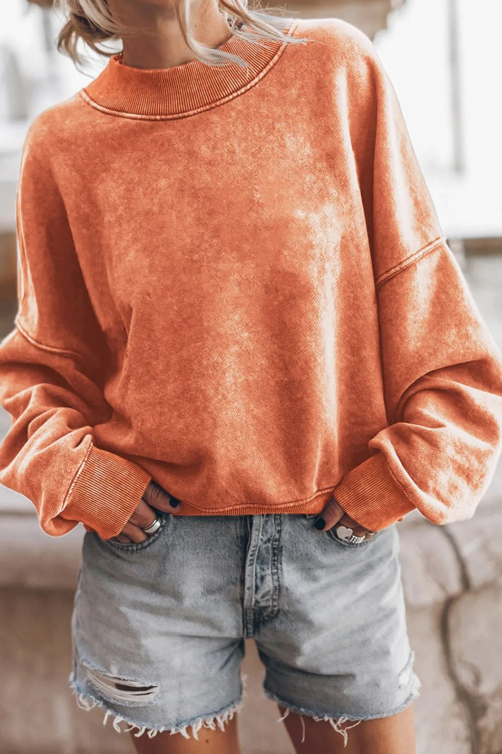 Orange mock neck dropped-shoulder sweatshirt with relaxed fit and long sleeves