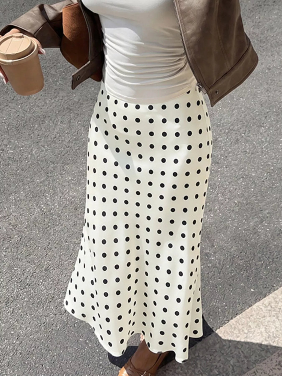 Beige polka dot stretch midi skirt, angled view of full front
