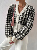 Houndstooth V-neck button-up cardigan with long sleeves and ribbed knit cuffs, black/white.