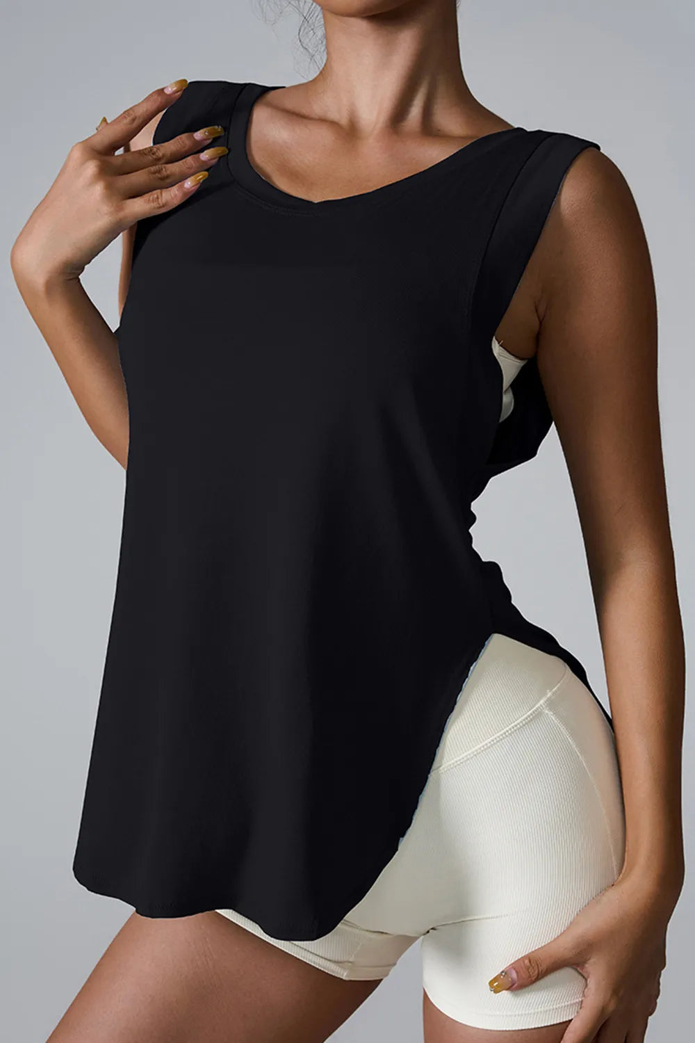 Black sleeveless active tank top with round neck and side slit hem