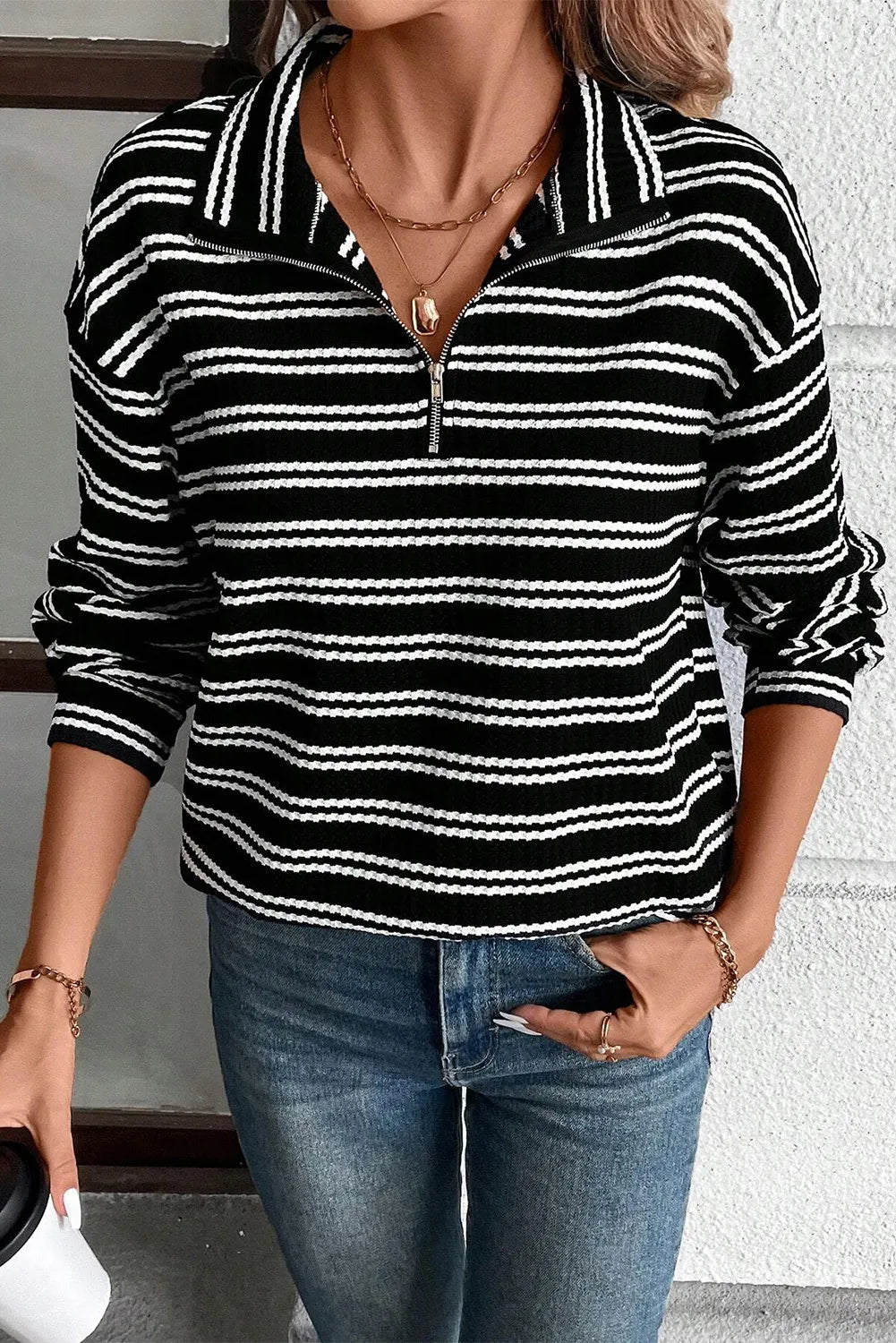 Black-and-white striped half-zip long sleeve top with ribbed cuffs