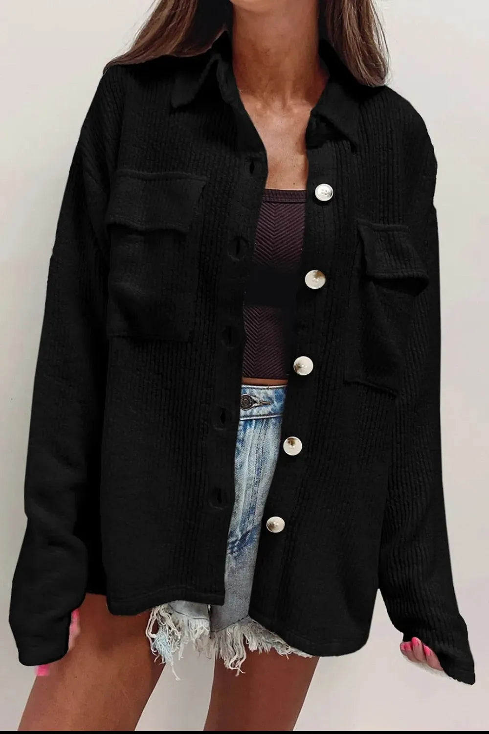 Black button-up long sleeve shacket with point collar, flap chest pockets, and metal buttons