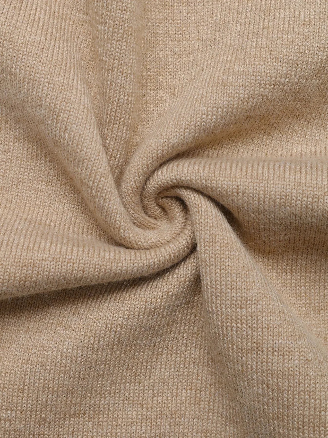 Close-up knit texture of beige color block sweater fabric with soft ribbed weave