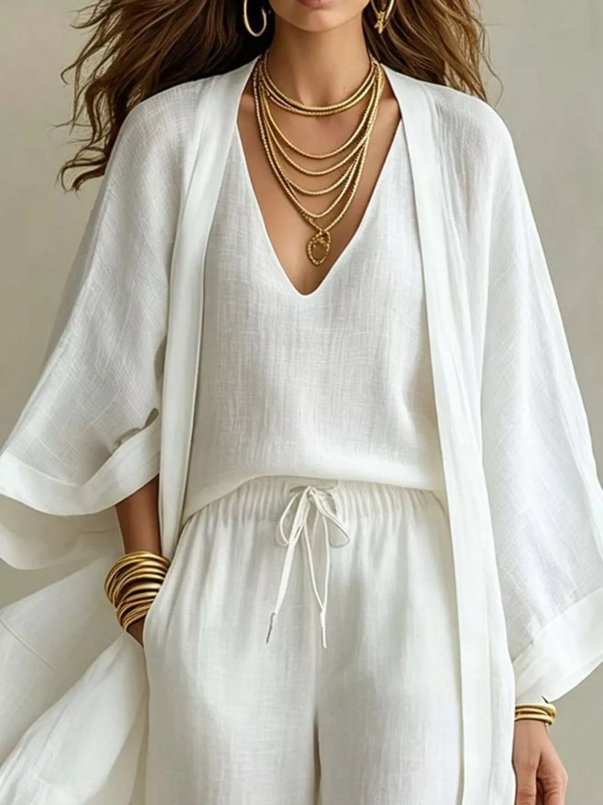 White V-neck top and drawstring pants with open cardigan sleeves, upper body view