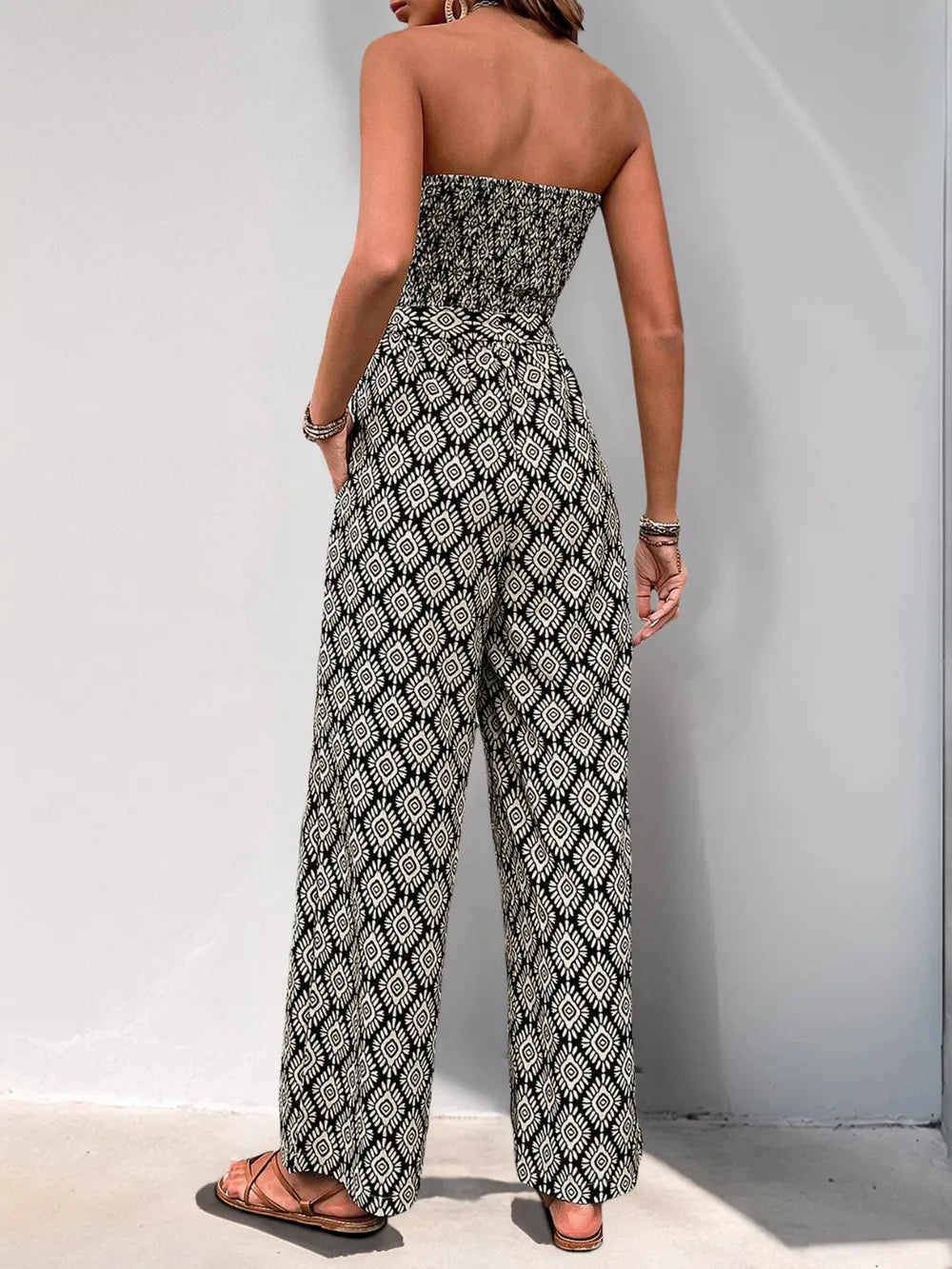 Black and white printed smocked sleeveless jumpsuit with open back look, wide-leg
