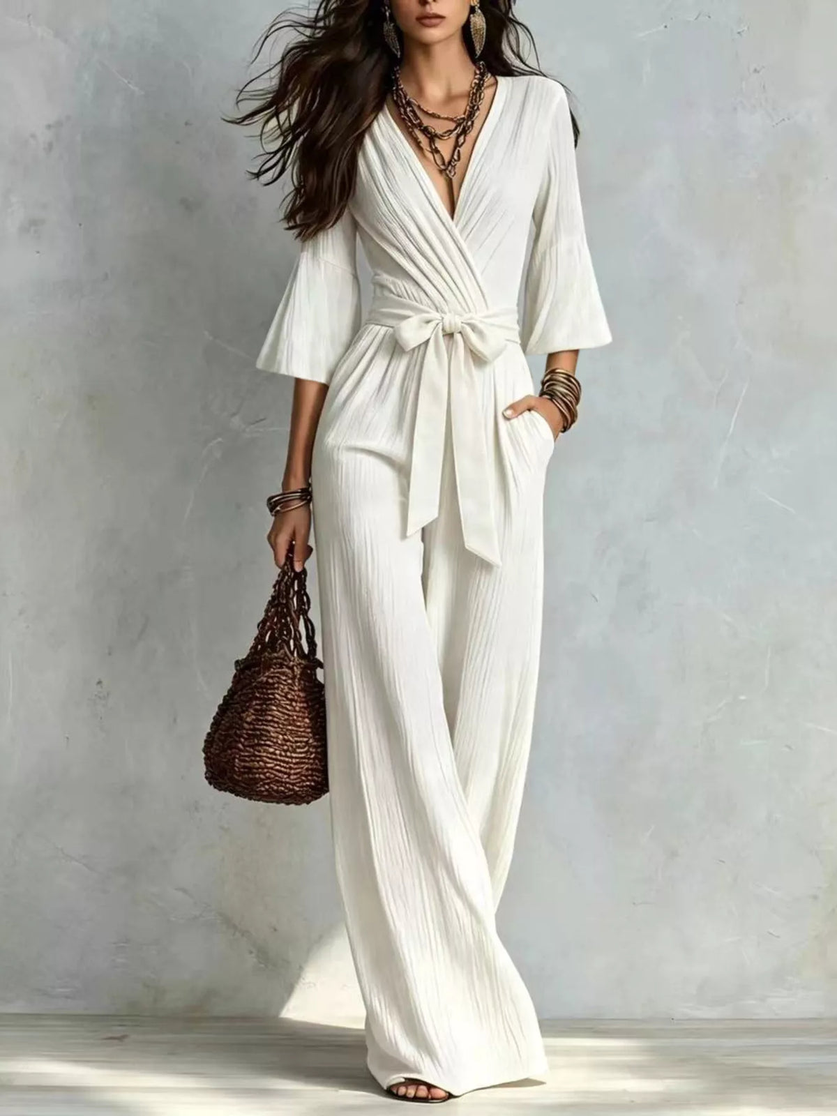 White pleated tie-waist wide-leg jumpsuit with V-neck and wrap bodice