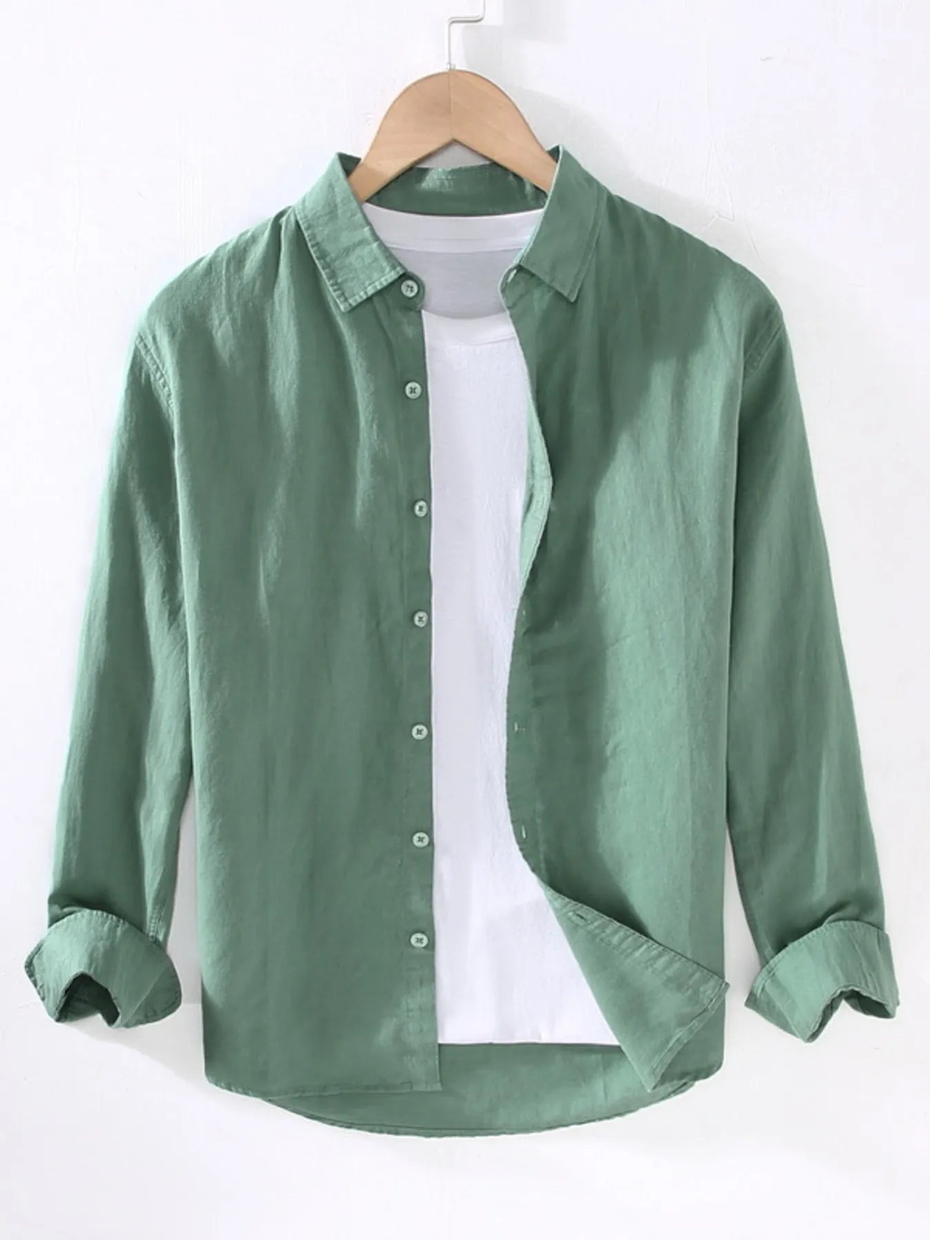Green button-up short sleeve shirt with pointed collar and front button placket