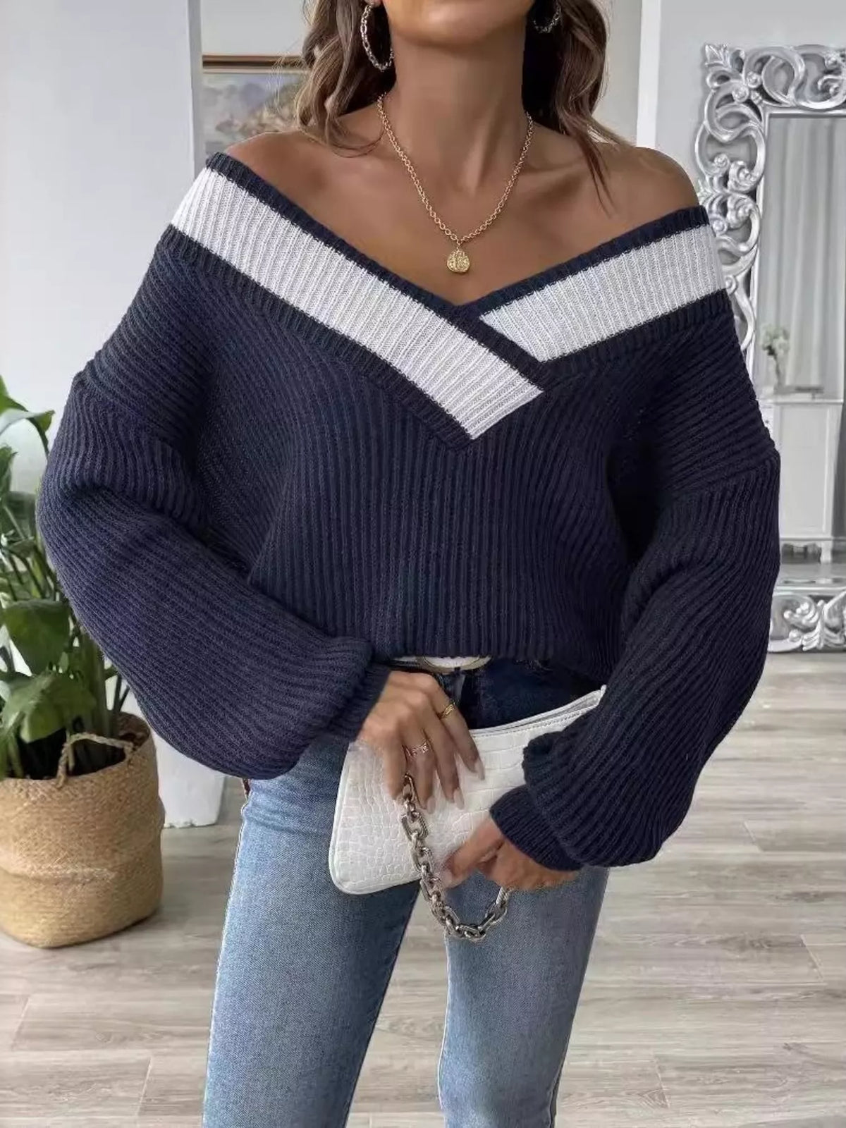Navy off-shoulder V-neck sweater with white contrast trim, long sleeves