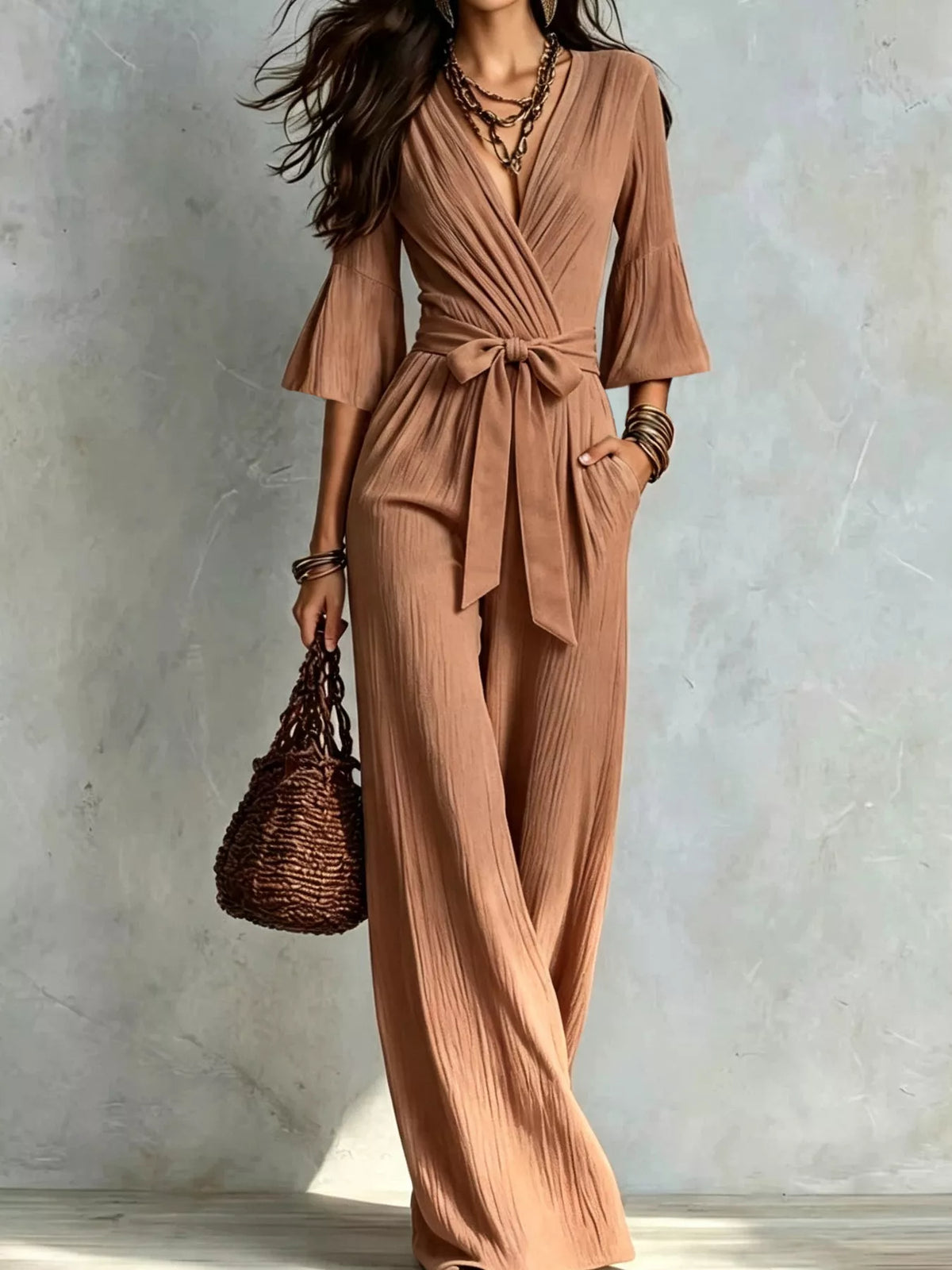 Light brown pleated tie-waist wide-leg jumpsuit with V-neck and wrap bodice