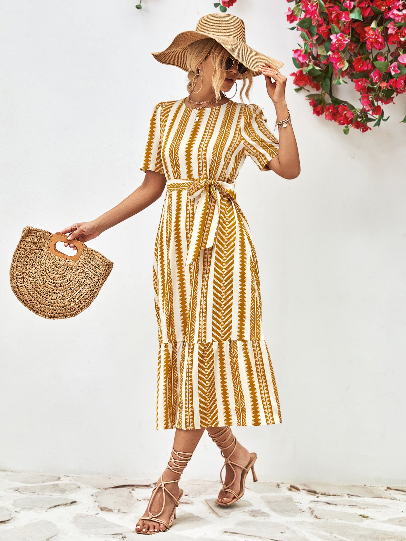 Gold striped round-neck puff sleeve dress with tied waist belt, side view.