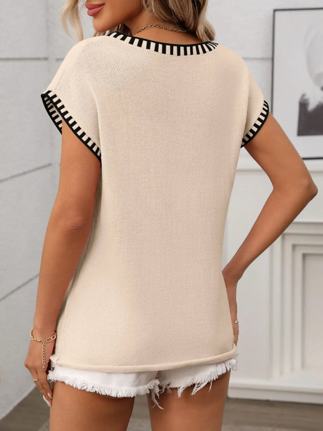 Tan knit top back view with black contrast trim and short sleeves