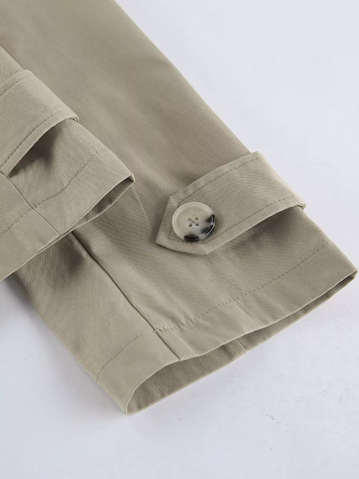 Khaki trench coat cuff with button closure and stitched hem