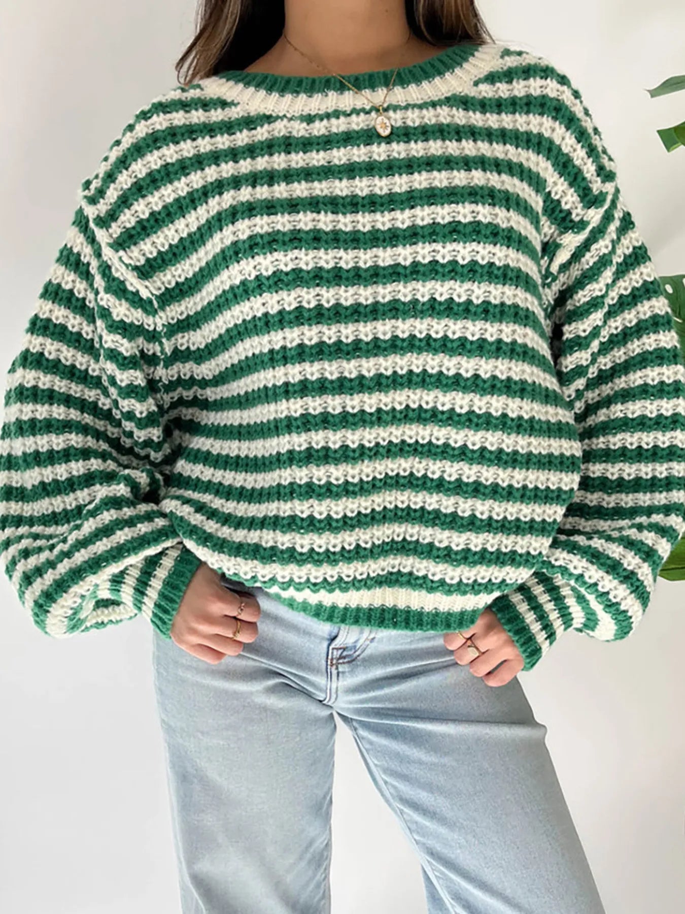 Green-and-white striped oversized drop-shoulder sweater with ribbed cuffs and hem
