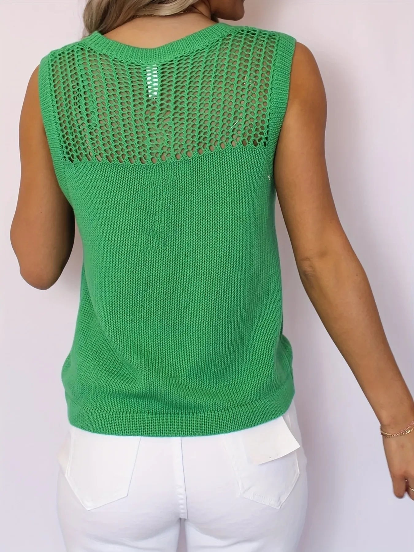 Green openwork knit sweater vest showing back yoke and straight hem