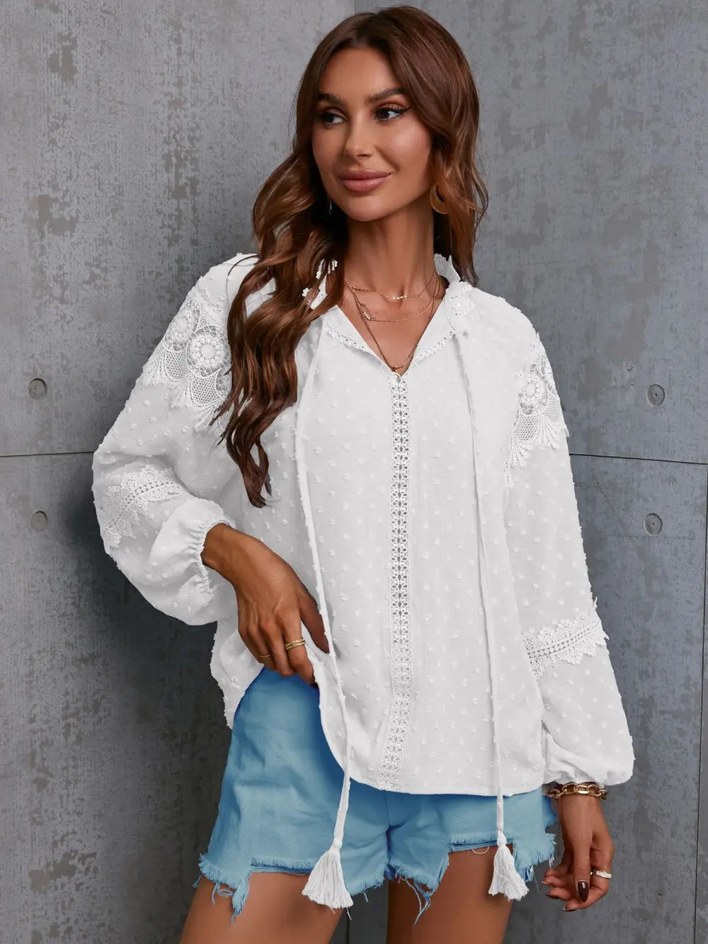 White crochet blouse with tie neck and long sleeves, textured front
