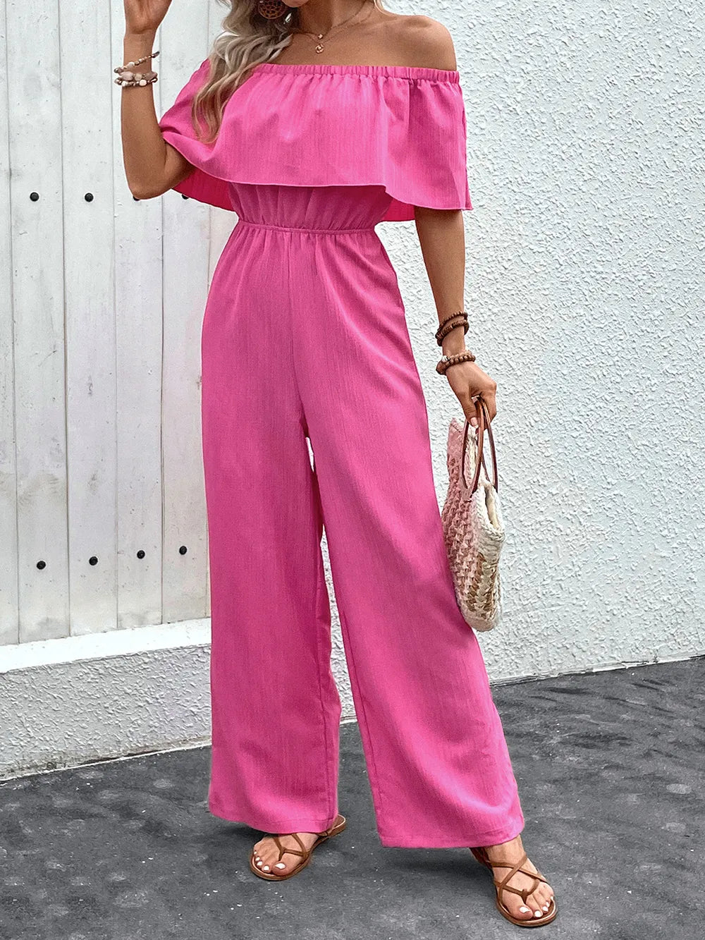 Hot pink off-shoulder wide-leg jumpsuit with ruffle neckline and elastic waist