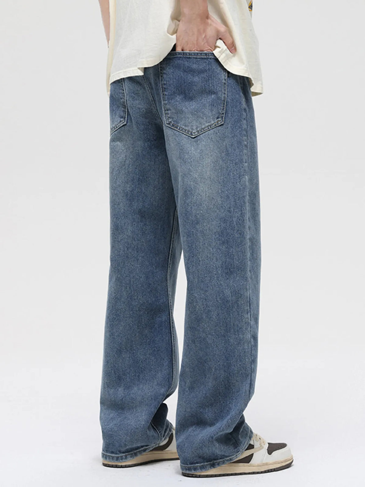 Vintage washed cotton stretch jeans, back view with yoke and patch pockets, medium blue wash