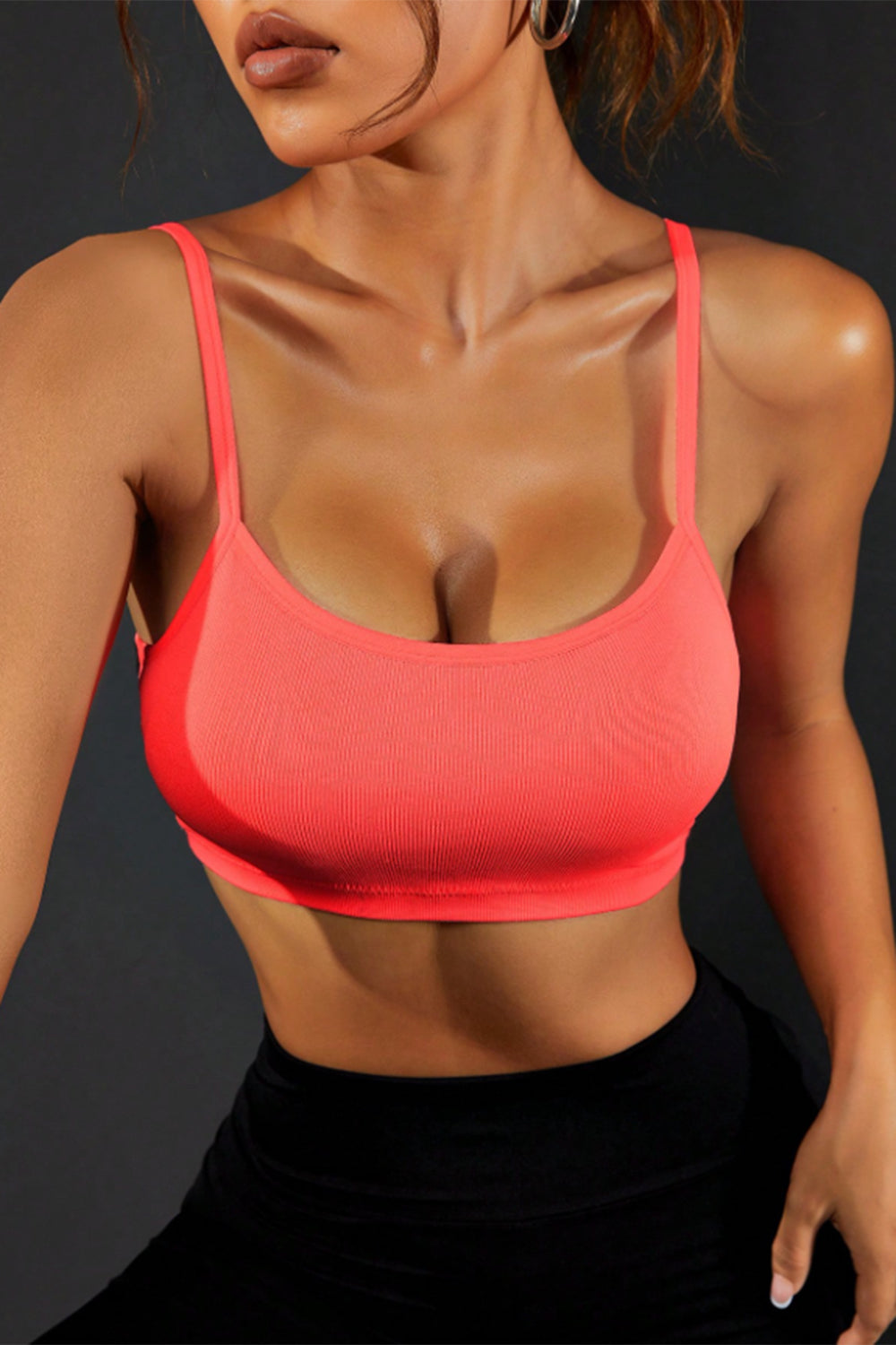 Coral sports cami with scoop neckline and racerback-style straps.