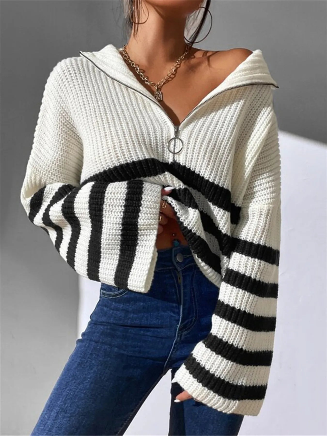 White cropped knit sweater with half-zip front and wide black-and-white stripe pattern