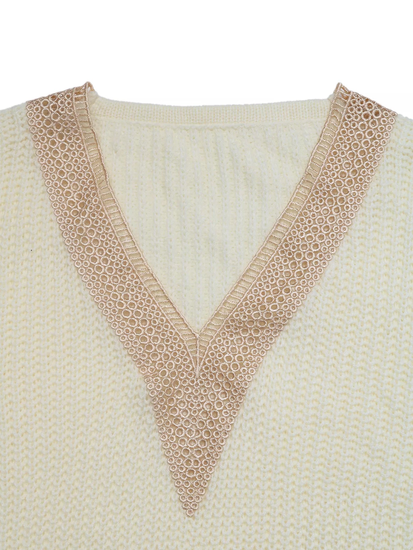 Close-up of ivory V-neck openwork trim on long sleeve sweater