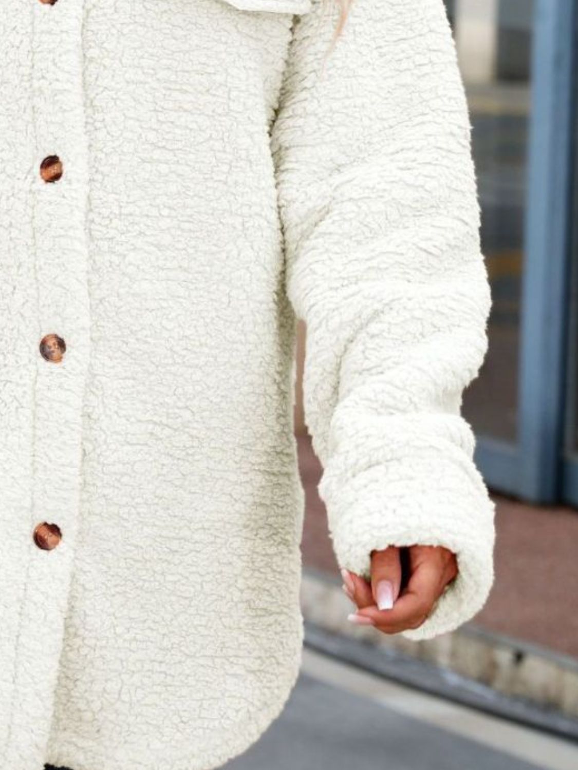 White textured collared coat sleeve with button detail and cuff gathers