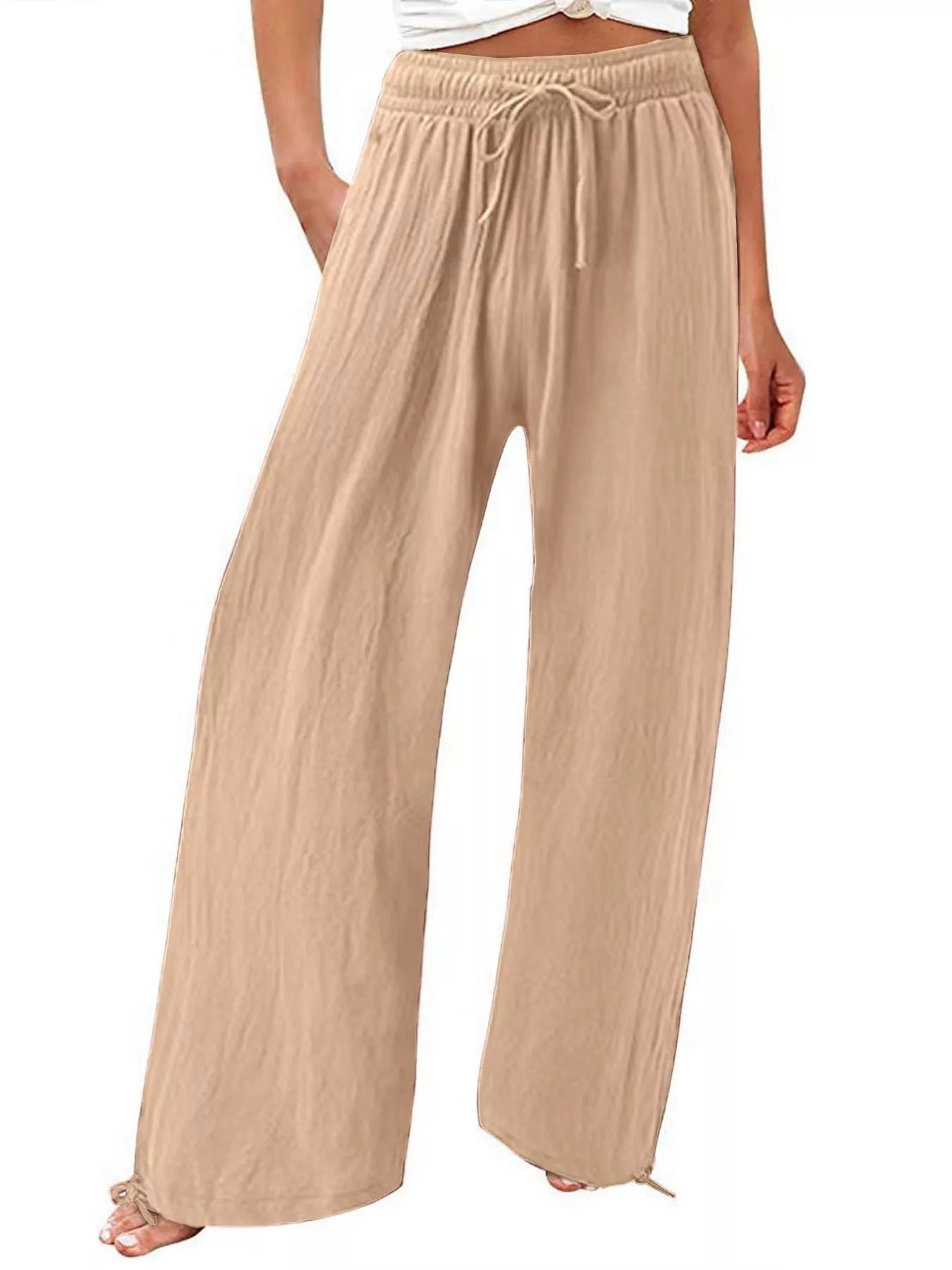 Beige wide-leg pants with drawstring waist and relaxed, flowy silhouette