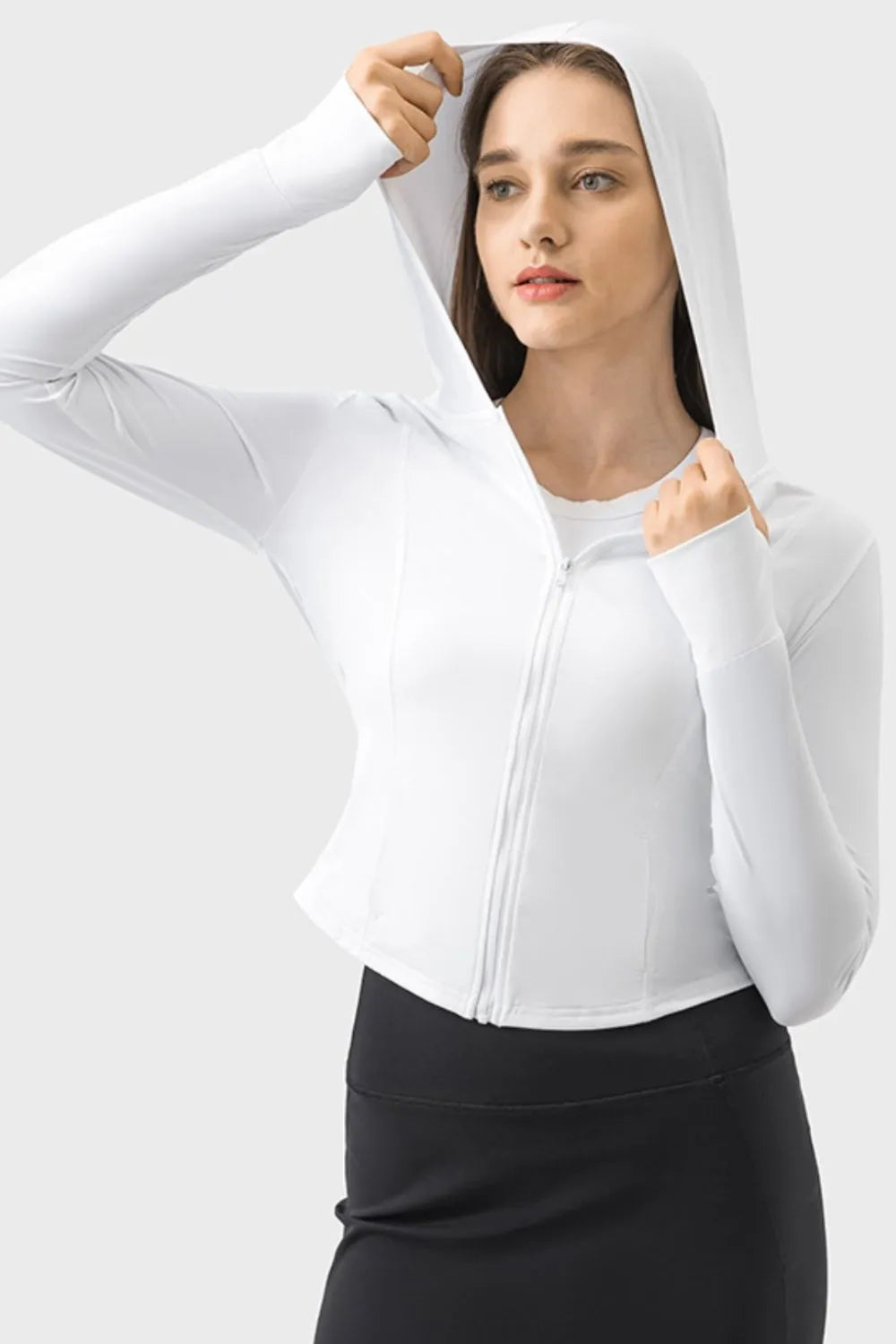 White zip-up hooded active jacket with long sleeves and hood up