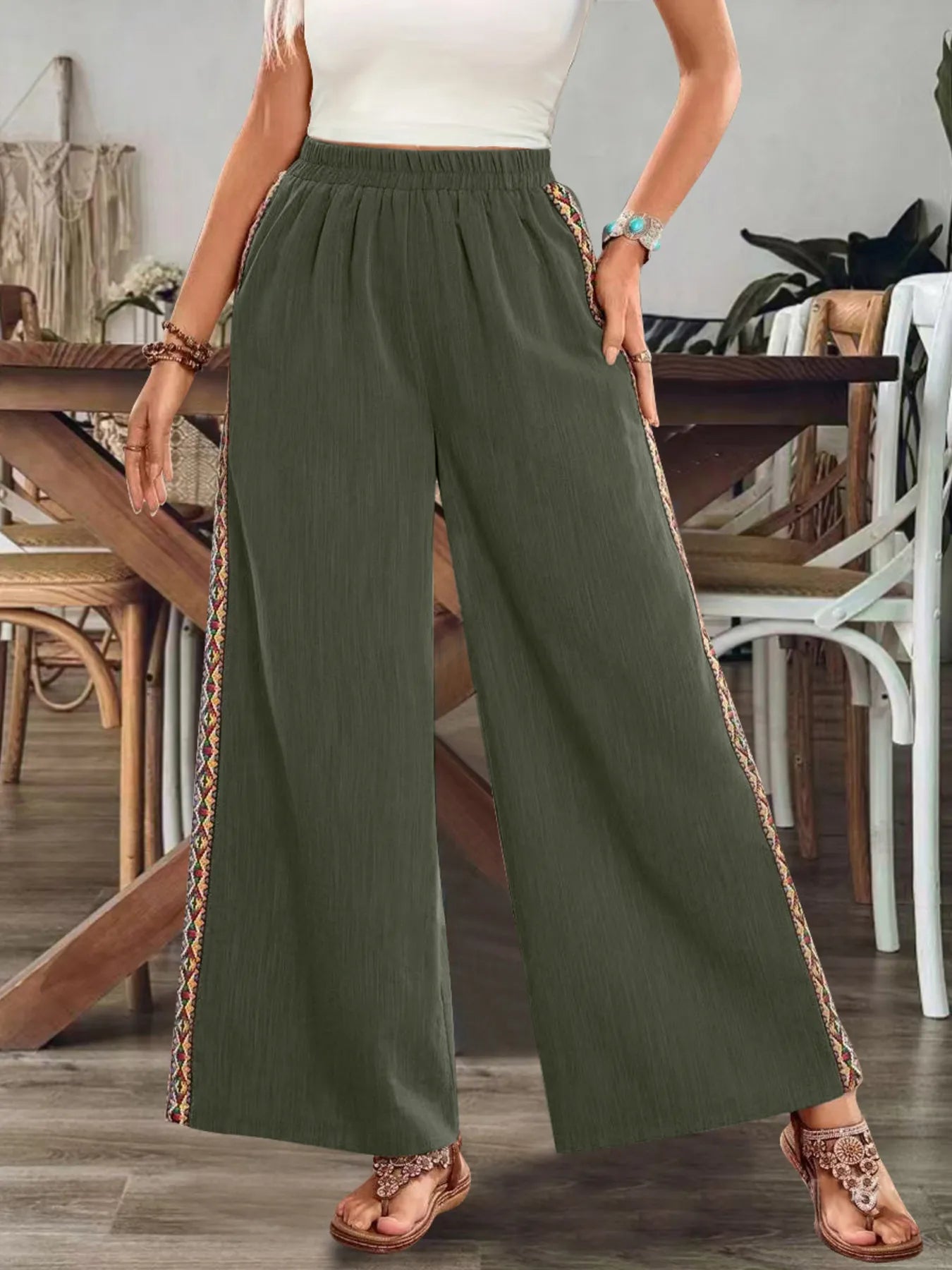 Olive green wide-leg pants with elastic waist and embroidered side stripe, breezy fit.