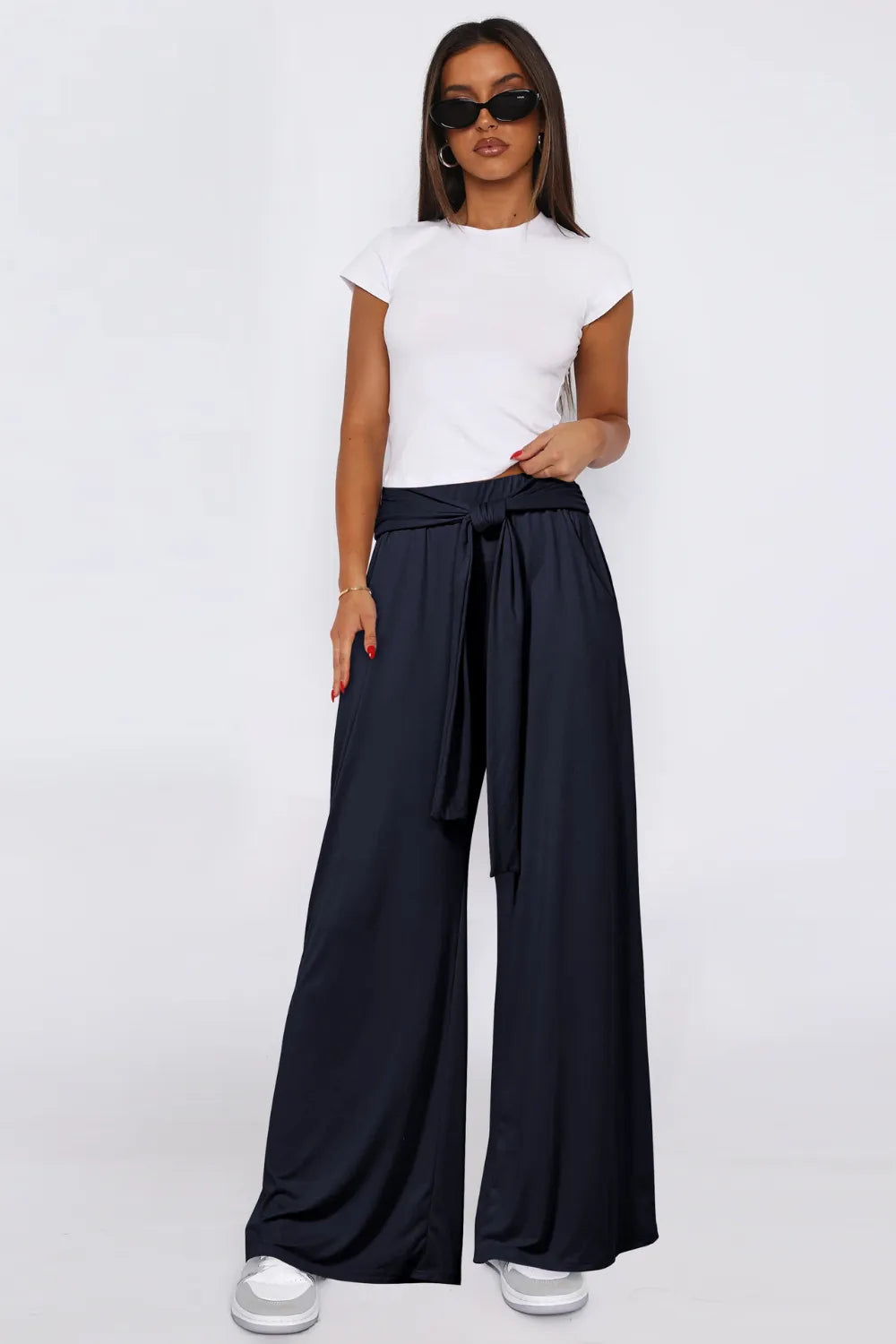 Dark navy wide-leg pants with tied waist, side pockets, wide relaxed silhouette.
